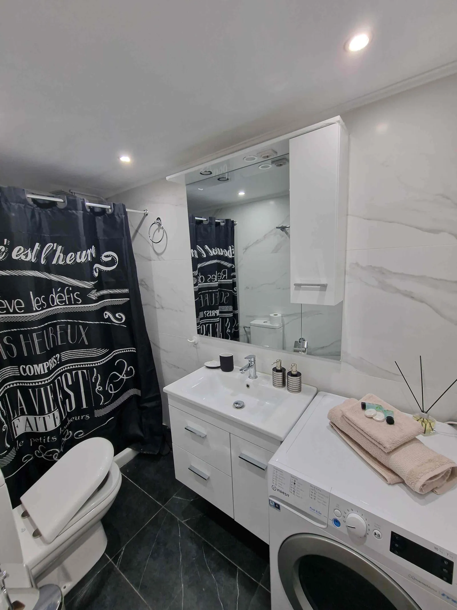 Bathroom with washing machine and shower